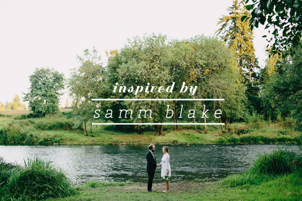 Bride and groom standing near a river holding hands by Samm Blake